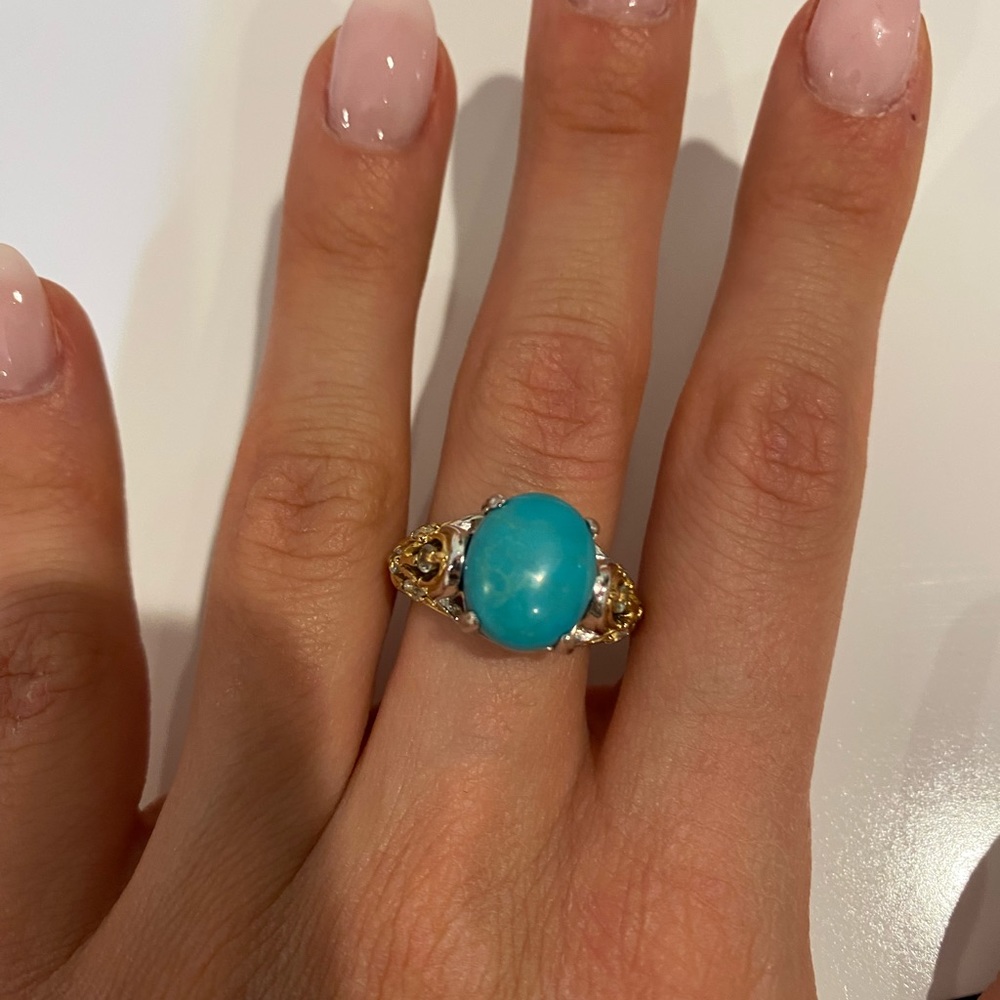 Ring with blue stone, silver band and gold details